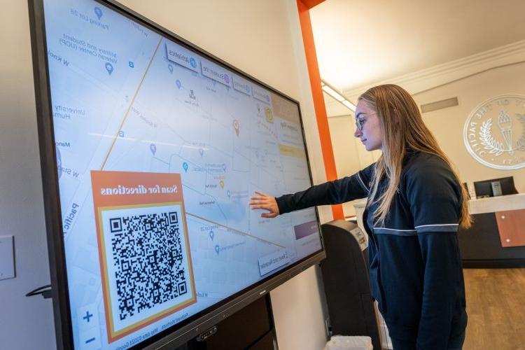 a student uses a new interactive campus map