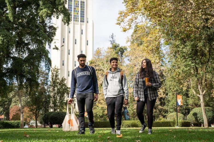 students walk across campus 