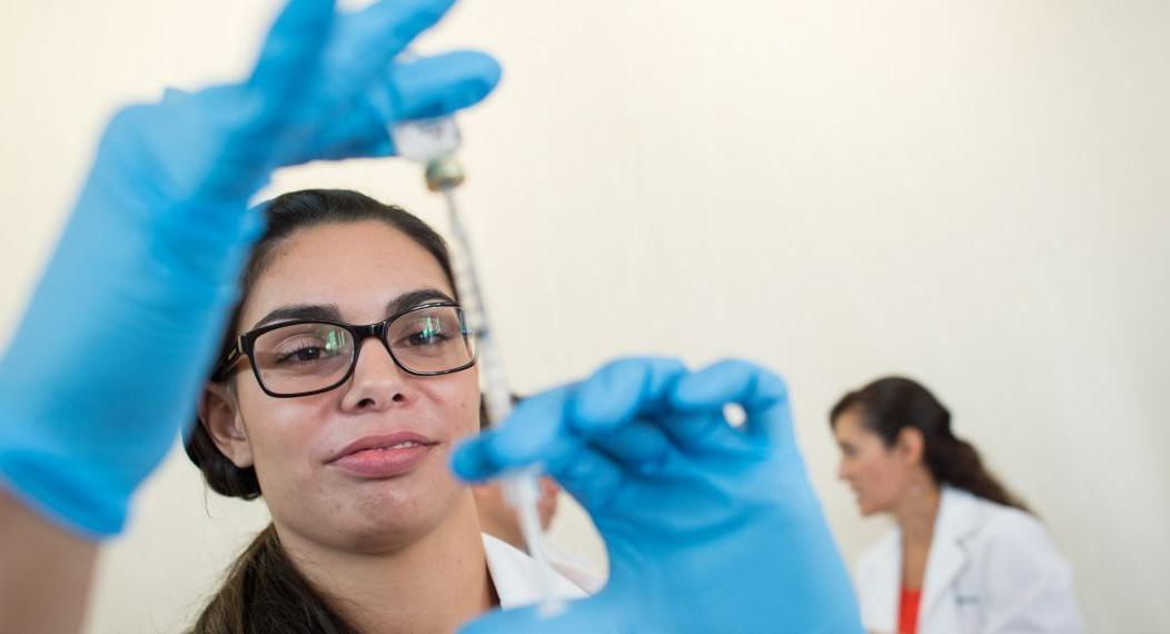 a pharmacy student prepares a flu shot