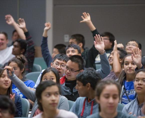 high school students raising hands