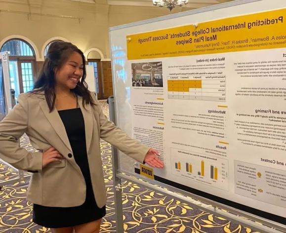 English major Brooke Tran presents research  on the relationship between international college students success and meal plan swipes.